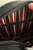 The Oblong Box Shop Haunted Holiday Cat Crossbody Purse, interior view showing colorful striped fabric lining with zippered pocket.
