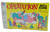 Milton Bradley Vintage Milton Bradley Operation Skill Game, a classic children's medical simulation board game with colorful cartoon illustrations of a doctor performing surgery on a patient, featuring labeled parts like "Broken," "Funny Bone," and "Adam's Apple," in bright yellow packaging.