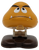 Nintendo 1989 Roomba 2-inch tall figure from Super Mario bros. Goombas are brown shiitake-like creatures with long black eyebrows, a sharp underbite, a tan stem, dark brown feet, no limbs, and are most commonly seen walking around aimlessly, often as an obstacle.
