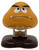 Nintendo 1989 Super Mario Bros Goomba 2-inch Figure (Loose), a small yellow figurine of a Goomba character from Super Mario Bros with a sad facial expression.