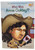 Product Penguin Workshop Who Was Annie Oakley? by Stephanie Spinner Paperback 2002, illustrated book cover featuring a cartoon portrait of Annie Oakley with a large cowboy hat and a playing card with a heart.
