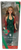 Mattel 2000 Barbie doll called "Holiday Surprise". Barbie has dirty blonde hair wearing a green dress with red & gold snowflakes and holding a red present with green ribbon. The box has a green ribbon look on the outside of the box.