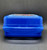 Hershey's Chocolate World souvenir plastic mini lunchbox by Whirley Industries. The case is blue with picture of the Hershey's Chocolate bar, Reese's Peanut Butter Cups and Hershey's Kiss riding the Chocolate World ride. The case is 5.5-inches wide x 7.25-inches tall x 3-inches high and Made in United States.