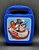 Hershey's Chocolate World souvenir plastic mini lunchbox by Whirley Industries. The case is blue with picture of the Hershey's Chocolate bar, Reese's Peanut Butter Cups and Hershey's Kiss riding the Chocolate World ride. The case is 5.5-inches wide x 7.25-inches tall x 3-inches high and Made in United States.