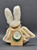 Moondust Goodspeed bunny rabbit hare ornament #5624-08 by Boyds Bears. The plush ornament is posable and was introduced in 1999 and now retired. Moondust Goodspeed is 5 1/2-inches tall and is wearing gold ribbon on head and gold buttons on chest.