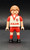 Geobra the German manufacture of Playmobil 2006 white jersey footballer / soccer player from the Playmobil 4700 Soccer Football Stadium set. The figure is wearing a white jersey with red sleeves, shorts and socks. The jersey also has FAIR in red letters across the front and 23 as soccer jersey number. The player has lever to create a kicking motion.