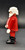 Geobra the German manufacture of Playmobil 1986 Santa Claus 3-inch tall figure for ages 3+. The figure is wearing a red Santa suit and black boots and belt. Santa is missing his hat and accessories.