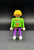 Geobra the German manufacture of Playmobil 1992 White basketball player (part #3000650) from 3867 Street Hoops Set 3-inch tall figure for ages 3+. The figure is wearing a green shirt with basketball in net and purple pants. The figure is missing his hat (part #3006669).
