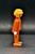 Geobra the German manufacture of Playmobil 1974 Pilot 3-inch tall figure for ages 4+ from the 3789 Rescue Helicopter set. The figure is wearing an orange flight suit and has blonde hair. The pilot is missing his helmet.