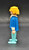 Geobra the German manufacture of Playmobil 1974 Policeman 3-inch tall figure for ages 4+. The figure is wearing dark blue shirt with white collar  and light blue pants. The policeman is missing his helmet and accessories.