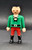 Geobra the German manufacture of Playmobil 2002 Pirate (part #30007040) from 3174 Red Pirateship Set 3-inch tall figure for ages 4+. The figure is wearing a green shirt with black belt and red pants. The figure is missing his headband (part #30205810) and his beard and hair