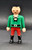 Playmobil GEOBRA PLAYMOBIL 2002 3174 Red Pirateship Pirate 3-inch Figure (Part #30007040), vintage pirate toy figure wearing a green lace-up shirt, red trousers, and black boots, shown standing against a dark background.