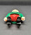 Playmobil GEOBRA PLAYMOBIL 2002 3174 Red Pirateship Pirate 3" Figure (Part #30007040), rear view of the small pirate figure lying face down, showing its green jacket, red shirt, black boots, and tan hands against a dark background.
