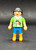 Geobra the German manufacture of Playmobil City Life basic girl figure that stands 2-inches tall for ages 4+. The figure is wearing a green shirt with white horse, white hood, blue pants and has black hair.