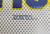 Tag Express Notre Dame Fighting Irish Roll-Up Mesh Auto Sun Shade by Tag Express – 18 x 14 inches, close-up of perforated mesh fabric in blue, gold, and white with the Tag Express brand marking.