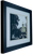 Side view of framed Notre Dame campus print showing frame edges and surface wear.