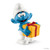 Smurfs Schleich Jokey Smurf Figure, a blue Smurf holding a yellow gift box with a red ribbon, wearing a white hat and shoes.