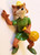 Disney's Animated Robin Hood With Loot Bag Toy Figure, colorful plastic figurine of Robin Hood holding a yellow loot bag and waving, wearing a green tunic and a yellow hat.