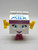 McDonald's Happy Meals - Food FUNdamentals Milly Toy Figure, a cartoon character with a milk carton body, blue eyes, pink shoes, and yellow arms.