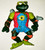Playmates Teenage Mutant Ninja Turtles - 1991 Mike the Sewer Surfer (Loose) Action Figure Toy, detailed green turtle figure with a red vest, sunglasses, and accessories including a small turtle figure on shoulder and a dolphin on arm.