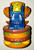 McDonald's Happy Meal Changeables - Series 1 Big Mac Toy, colorful plastic toy of a mini Big Mac burger with layers of lettuce, cheese, tomato, and buns, featuring a small blue and yellow construction vehicle or robot with detailed design on top.