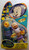 Warner Bros. Duck Dodgers Space Cadet Action Figure, plastic toy figure of a cartoon pig in space suit with a purple helmet and gloves, standing next to a blue and yellow spaceship with a yellow antenna, in colorful packaging with cartoon character images and comic-style text.