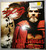 NECA 300 King Leonidas Resin Mini-Bust, detailed figure of King Leonidas from the movie 300, with a beard, armor, and red cloak, displayed on commercial packaging with promotional graphics.