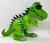 Hasbro Playskool Heroes Jurassic World T-Rex Figure, a large green toy dinosaur with black spikes and detailed textured skin.