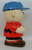 Benjamin & Medwin Peanuts 'Charlie Brown' Cookie Jar, a ceramic cookie jar shaped like Charlie Brown from Peanuts, wearing a blue cap and a red shirt, holding a football, with a glossy finish and vibrant colors.