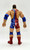 WWE 2001 Kurt Angle Action Figure (Loose), detailed back view of a wrestling toy with patriotic American flag design, wearing red, white, and blue attire with protective blue knee and elbow pads.