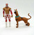 WWE 2011 Sin Cara and Scooby Doo Wrestlemania Mystery Action Figures, loose action figures of Sin Cara in red and white wrestling attire with a mask, and Scooby Doo with a brown body, black spots, and a blue collar, standing on a plain white background.