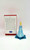 Hallmark Keepsake Ornament: Disney Frozen - Queen Elsa, detailed figurine of Queen Elsa from Frozen in her iconic blue gown with snowflake patterns and blonde hair, standing on a blue snowflake-shaped base with packaging behind.