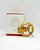 Hallmark Keepsake Ornament: The Hunger Games Catching Fire - Mocking Jay, gold mockingjay pin ornament with intricate details and a circular design.