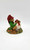 Cairn Studio, LTD Tom Clark Gnomes - Alfie (No Box), detailed gnome figurine of a gnome in a green outfit and red hat holding a bottle, sitting on a log with a sack and small wood pieces.