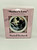 Norman Rockwell "Mother's Love" Collector Plate, pink box packaging featuring a detailed image of a mother caring for her child in bed.