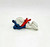 Smurfs Vintage PEYO 4.0201 Bobsled Smurf PVC Figure, depicting a colorful, vintage plastic figurine of a Smurf bobsledder with blue, white, and red colors, lying flat on a white background.