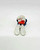 Vintage PEYO 4.0201 Bobsled Smurf PVC Figure, a small collectible figurine of a Smurf sitting with red object in hand and wearing blue pants and white hat, on a plain white background.
