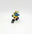 Smurfs Vintage PEYO 4.0205 Skier Smurf PVC Figure, blue Smurf figurine with a white hat and yellow sweater, riding a snowboard with a white background.