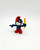 Smurfs Vintage 1981 Schleich 4.0224 Teacher Papa Smurf PVC Figure, a small figurine of Papa Smurf with glasses, holding a yellow ruler, wearing a red hat and pants, and a white beard.