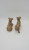 Kenmar Large Brown Cow Salt & Pepper Shakers Set, ceramic cow-shaped salt and pepper shakers in a sitting position with detailed features.