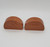 AVON Avon Terra Cotta Salt & Pepper Shakers Set, terracotta-colored salt and pepper shakers with carved animal and decorative patterns.