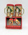J.S.N.Y. Old Fashioned Santa Mini Salt & Pepper Set, vintage metal spice shakers featuring Santa Claus carrying a Christmas tree with reindeer and winter background, with red lids and gold accents, displayed on their original packaging box.