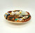Pillsbury Doughboy Italian Zucchini Crescent Pie 3-D Collector Plate, detailed collectible ceramic plate featuring the Pillsbury Doughboy dressed as a chef, surrounded by cooking utensils, ingredients, and kitchen scene elements.