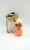 Cherished Teddies 2001 Cherished Teddies #873373 Peach Spring Bonnet Figurine, teddy bear wearing a pink dress and a peach-colored spring bonnet, in original packaging.