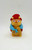 Hasbro Glo Friends Grannybug Mini Figure, colorful small toy figurine with a cartoon character appearance wearing a blue scarf and red hat.