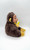 Unbranded Monkey Eating Banana Stuffed Animal, plush toy of a monkey with a realistic face, brown furry body, yellow hands, feet, and ears, holding and eating a plush banana, soft and cuddly for children.