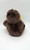 Unbranded Monkey Eating Banana Stuffed Animal, soft plush toy of a monkey with a fuzzy brown body and yellow ears, viewed from the back.