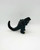 Trendmasters Supercharged Godzilla Action Figure (Loose), black Godzilla toy with textured body, tail, and sharp teeth, standing on a white background.