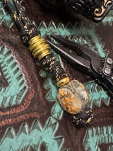 Gold Flake Resin and Shredded Money Resin Knife Nub with Polished Brass Spindle and Spacer on Black/Gold Paracord