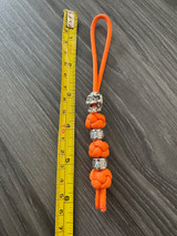 Small Hunter Orange Paracord Knife Lanyard with Skull and Carbon Silver Beads